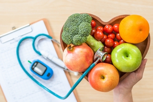Basket of vegetables and fruit next to a stethoscope