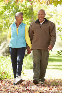 Active African-American senior couple on an autumn walk