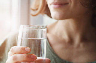 woman holding water glass, drinking water, hydration