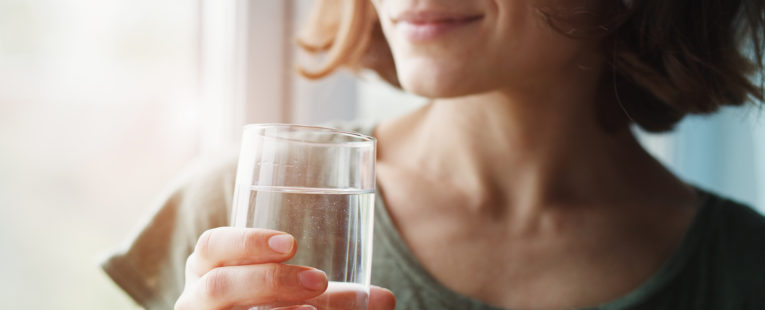 woman holding water glass, drinking water, hydration
