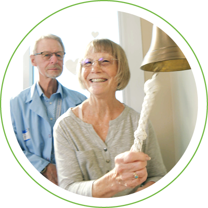 Female cancer patient ringing bell after completing treatment